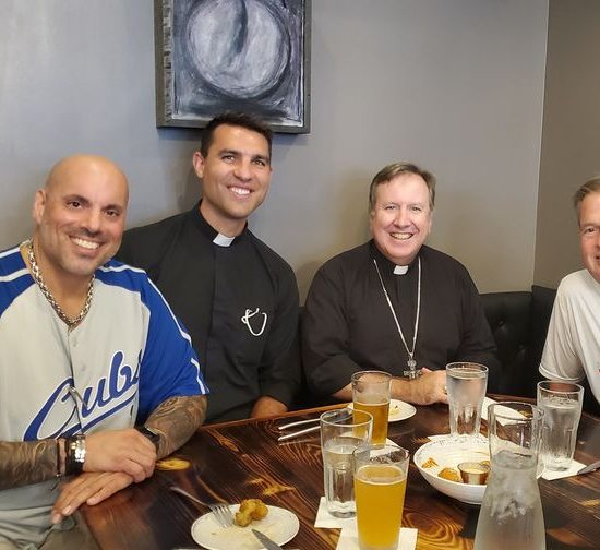 People smiling over food.